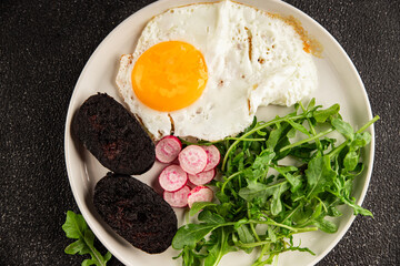 Eggs breakfast black pudding, egg, vegetables, arugula portion size natural product tasty snack fresh delicious gourmet food background on the table rustic top view copy space
