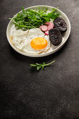 Eggs breakfast black pudding, egg, vegetables, arugula portion size natural product tasty snack fresh delicious gourmet food background on the table rustic top view copy space