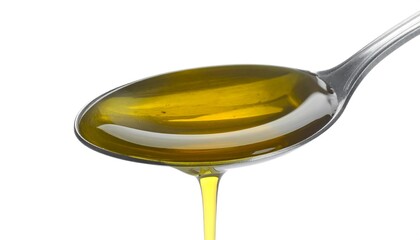Golden oil pouring from spoon