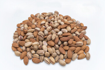 Mix of roasted pistachios and almonds isolated on white background.