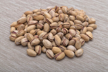 Roasted salted pistachios in shells, traditional snack food.	