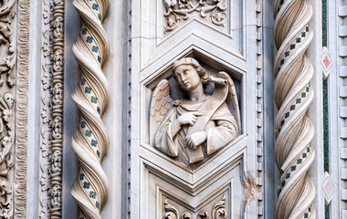 high relief of an angel detail of the facade of the cathedral Santa Maria del Fiore in Florence