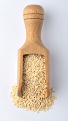 Wooden scoop filled with sesame seeds