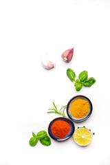 Food, cooking, spices background, ground chili pepper and turmeric, rosemary, garlic, lime, Indian and Asian cuisine ingredients, white copy space, top view