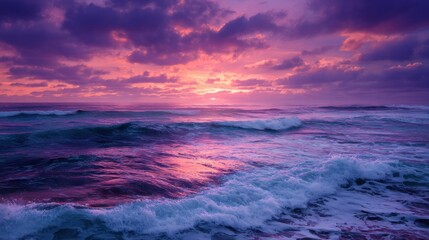 Obraz premium A vibrant sunset casts purple and pink hues across the sky as waves crash against the shore. The serene ocean scene captures the beauty of nature during early evening.