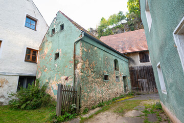 Old village courtyard  with weathered houses in quiet alley in Kastl, Germany