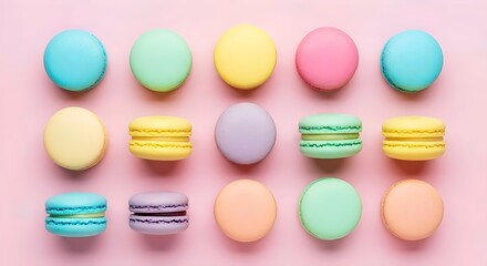 Flat lay of colorful macarons on pastel pink background french cookies