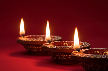 Decorations Diwali oil Lamp in the red background. Celebrations Deepavali festival of lights.