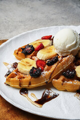Indulge in our Delicious Waffles topped with Fresh Fruits, whipped
