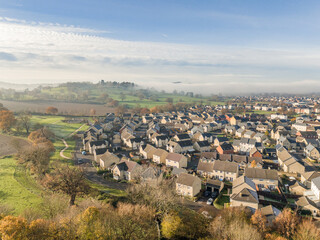 A drone view of a contemporary housing estate with fields and countryside