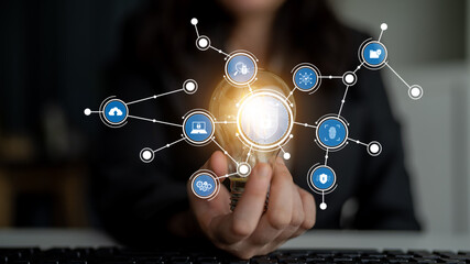 A person holds a glowing light bulb, symbolizing creativity and innovation, while various digital icons connect, illustrating the intersection of technology and ideas. Tessel