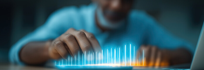 Person interacting with holographic data visualization displaying blue illuminated statistical charts.