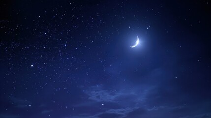 Naklejka premium A crescent moon glows softly among countless stars in a clear night sky. The serene landscape below offers a peaceful atmosphere enhanced by gentle clouds.