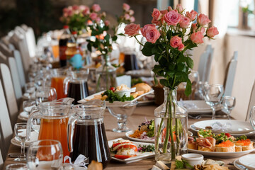 Elegant Wedding Reception Table Setting with Pink Roses, Fresh Food, and Orange Juice on a Luxurious Banquet Scene
