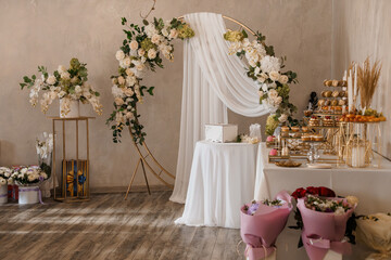 Elegant Wedding Dessert Table with Floral Arch Backdrop  Ivory, Gold and White Modern Celebration Decor Setting