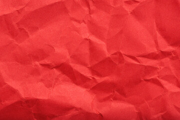 Red wrinkled paper texture with folded creases and shadows