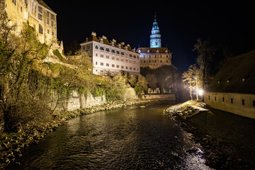 Night view of historic castle above river in Cesky Krumlov