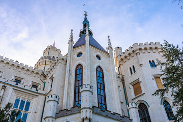 Fototapeta premium Majestic gothic castle tower with turrets and blue sky background