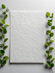 Blank textured card with green leafy branches on white background, perfect for eco-friendly wedding invitations, botanical stationery, or natural design mockups.
