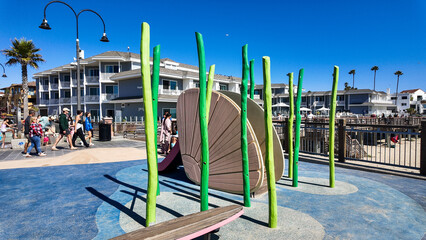 Pismo Beach Looking at the Pier City Plaza and the Playground with a Whale Slide and other underwater themes for kids to play on at the Beach