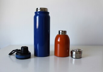 Composition with colorful reusable and stainless thermal bottles for sports, travel