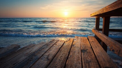 A wooden pier juts out over the calm ocean waters as the sun sets on the horizon. The vibrant sky reflects warm hues, creating a serene and peaceful atmosphere for relaxation.