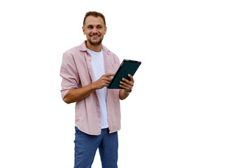 Smiling man standing, holding and interacting with a digital tablet, enjoying mobile technology and online communication
