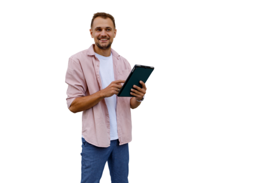 Smiling man standing, holding and interacting with a digital tablet, enjoying mobile technology and online communication