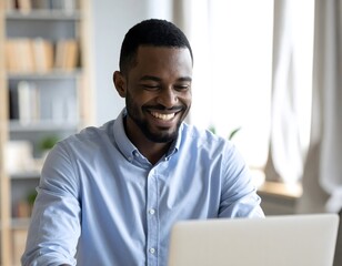 A bright and authentic medium close-up of a Black man laughing during a video call in his well-lit, personalized home office.