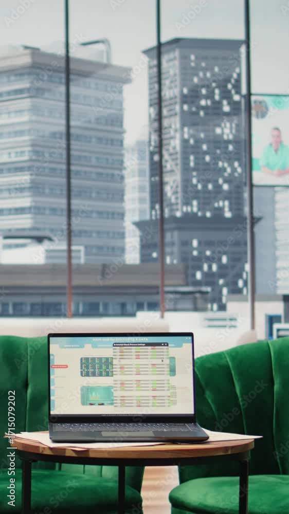 Poster vertical video modern high end empty office space with a laptop running infographics and data report