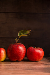 Freshly picked red apples, autumn rustic wooden background, dark, moody style