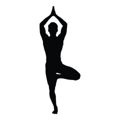 Fototapeta premium A person performing a tree pose yoga position black silhouette