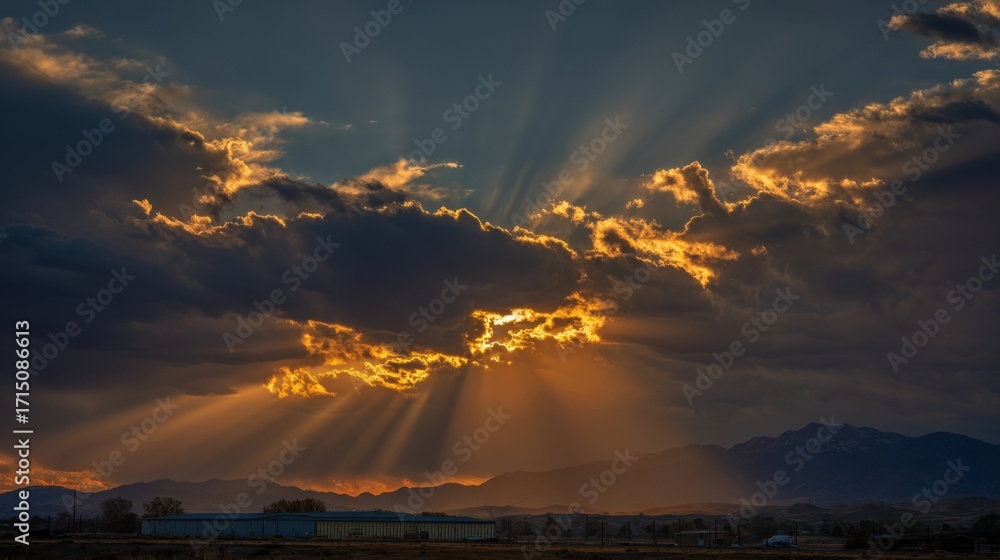 Poster golden rays of sunlight break through dark clouds during sunset, creating a breathtaking display in 