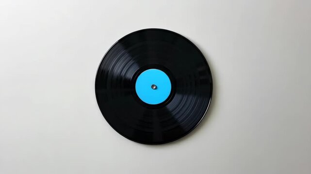 Record with music on a turntable against white background.