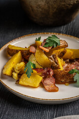 Roasted potatoes with bacon and parsley.