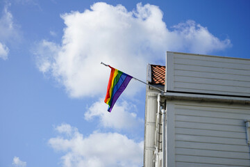 Rainbow pride flag on a white wooden house in Norway.