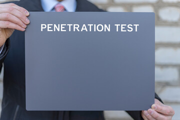Penetration test ( pentesting ) concept. Business person holding template gray banner sees the inscription penetration test. Cyber security privacy data protection business technology.