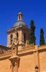 Fototapeta premium Ciudad Rodrigo, Salamanca District, Extremadura, Castilla y Leon, Spain. The Baroque and Romantic style Cathedral. Intricate bell tower and cypress trees. 