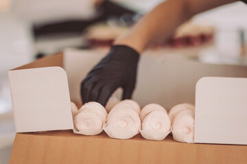 Delicate hands prepare sweet meringues for a dessert display in a cozy bakery during the afternoon