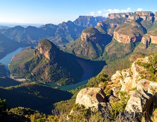 Panoramic view of a vast valley with towering cliffs and a winding river