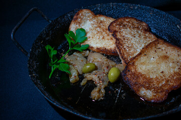 Toasted bread with olives and pickled eggplant
