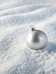 Minimalist background with single silver bauble on white snow-textured surface, premium card design