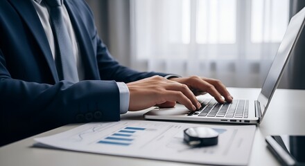 Businessman analyzing financial reports in office, man in suit working with charts and laptop, financial data analysis and planning, accountant working on company balance sheet