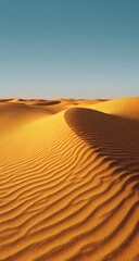 Golden desert dunes stretching to a clear, azure sky under warm sunlight, showing textural detail of rippled sand