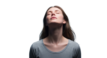 Close-up of a woman with eyes closed, head tilted back, in soft light