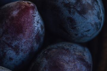 close up of dark purple Italian plums, prunes