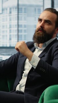 Vertical Video Male entrepreneur studying investments on a hologram illustration, using holography technology for productivity in smart office corporation. Boss looks at holographic image. Camera B.