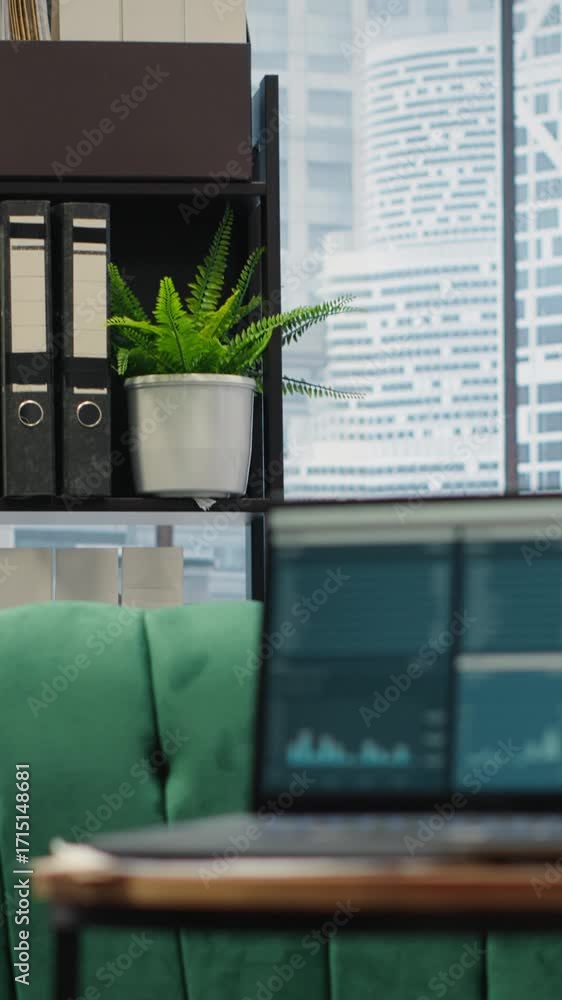Poster vertical video modern high end empty office space with a laptop running infographics and data report