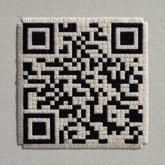 Black and white QR code embroidered on white, subtle texture meets modern tech in minimalist detail.