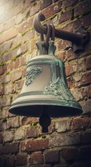 Fototapeta premium Antique Bronze Bell Displaying Ornate Carvings on an Old Brick Wall